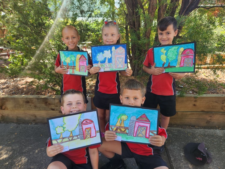 Five students holding artwork showing a farm scene