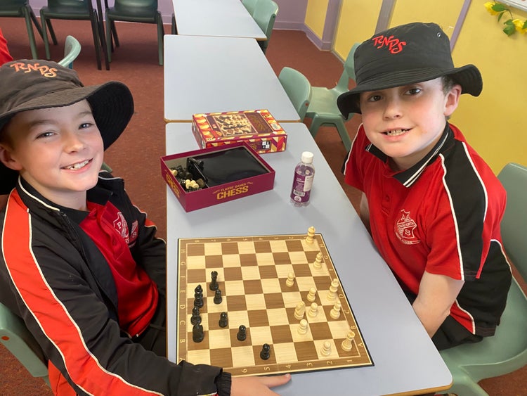 Two students playing the game of chess